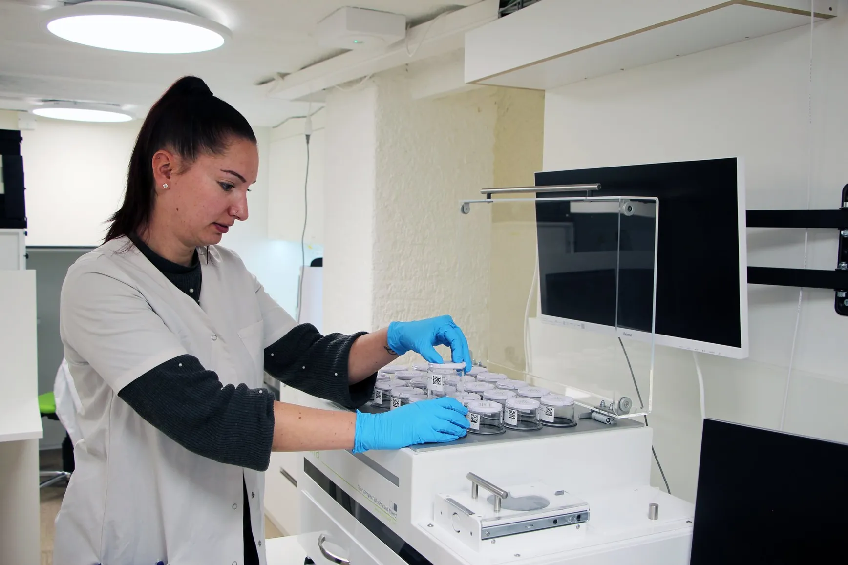 A member of staff preparing weekly doses at the blister machine