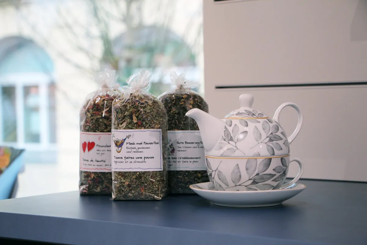 Herbal tea bags and a teapot on the window table of the pharmacy